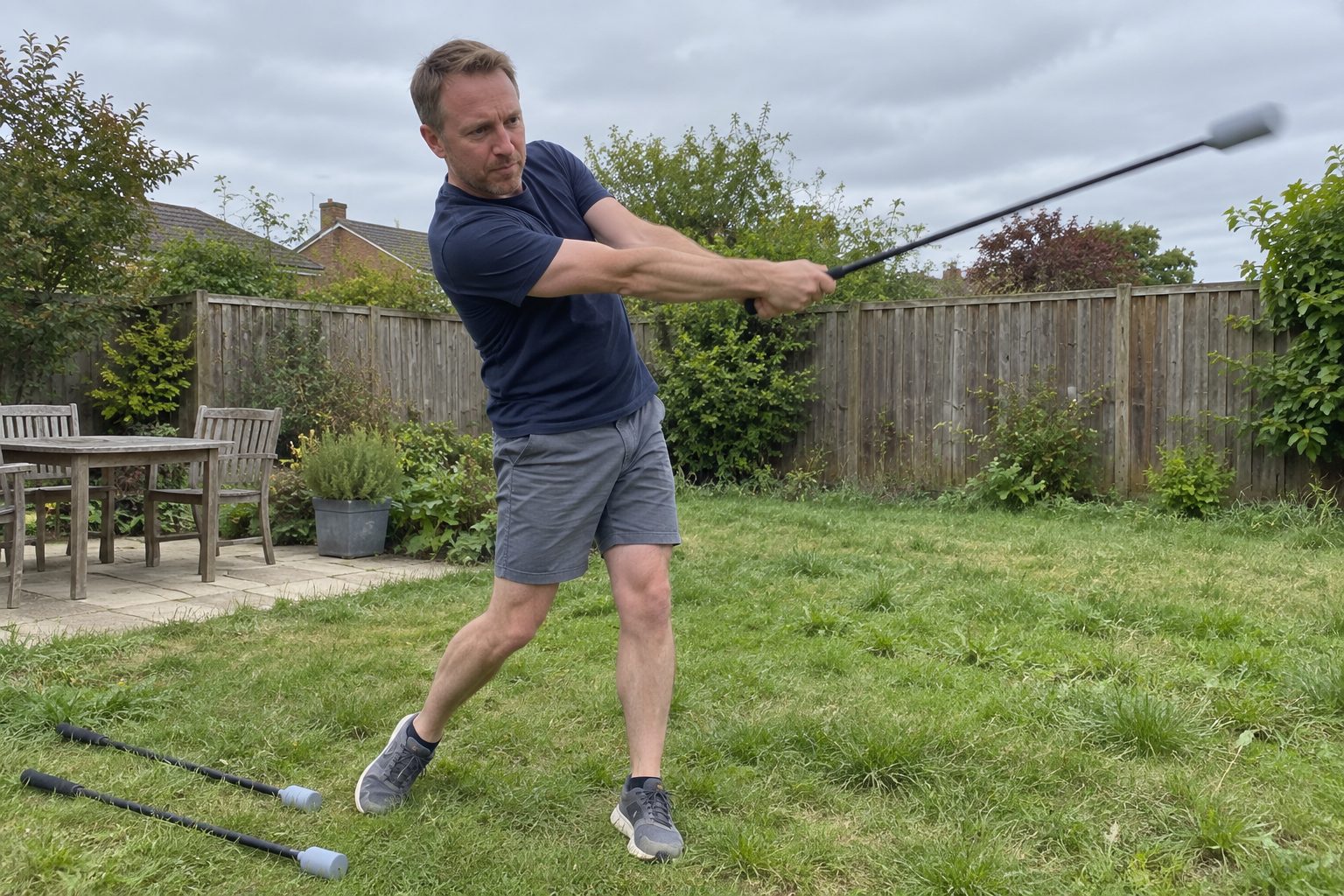 The author swinging a light speed training stick hard in his backyard