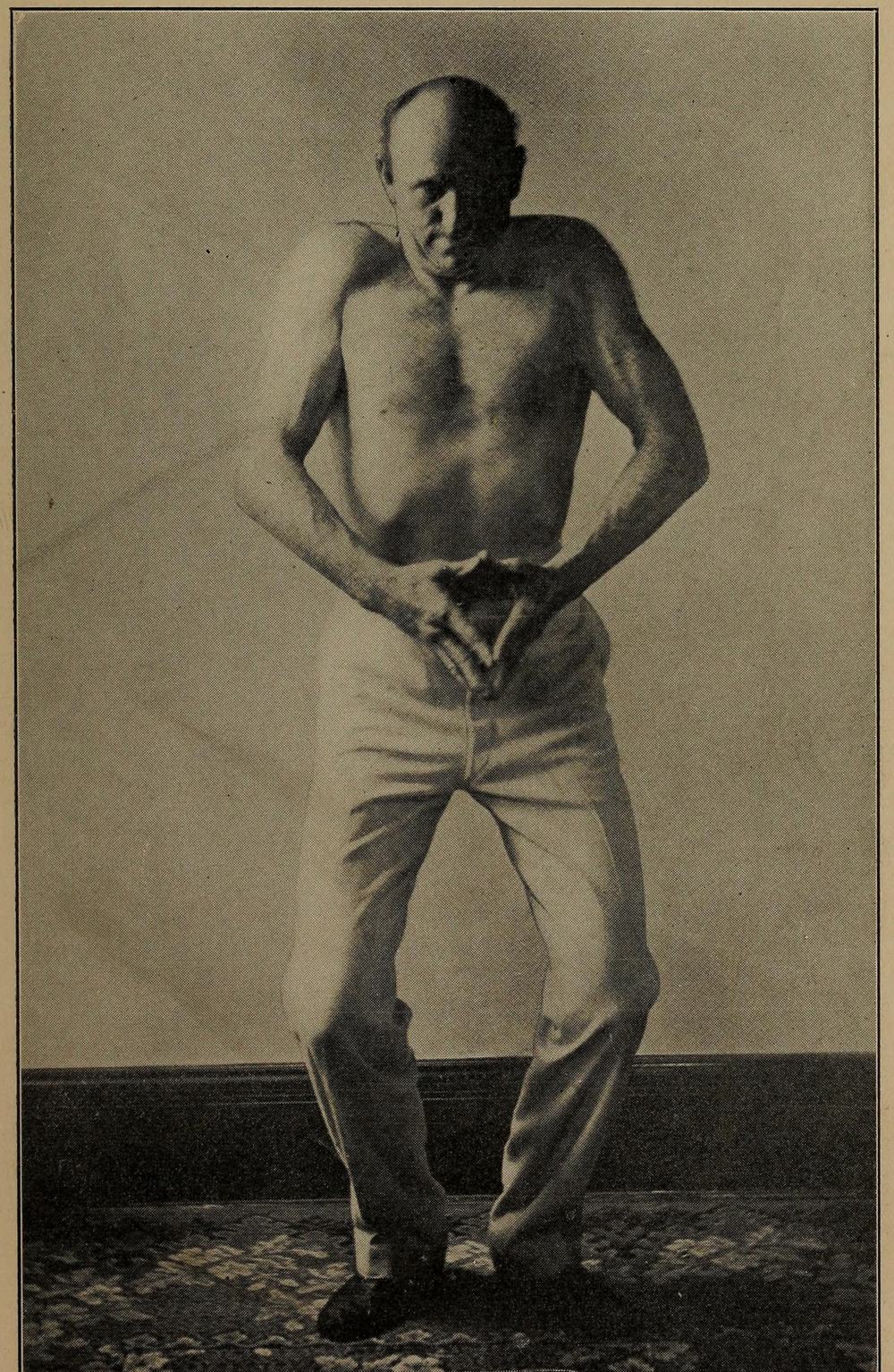 Bob Fitzsimmons, bare-chested, demonstrating a neck and shoulder exercise in a 1901 photographic plate