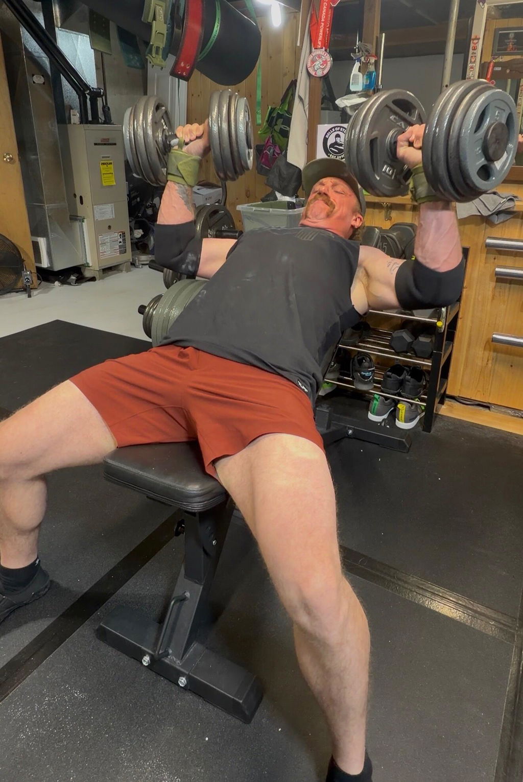 Dumbbell bench press performed with two loaded adjustable handles