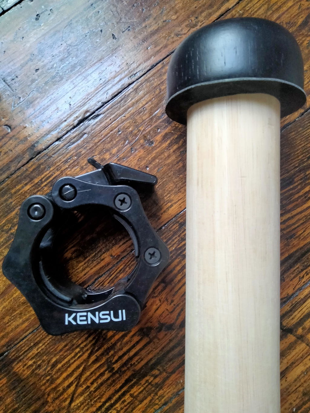 Close view of the mace collar and handle on a wood floor