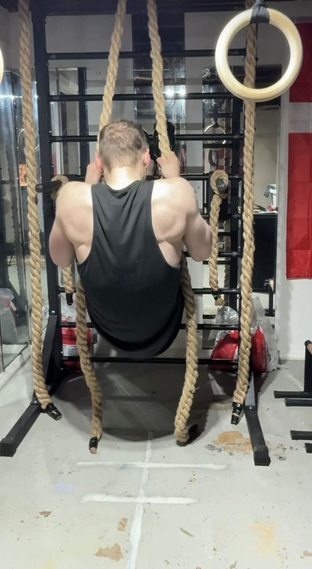 Rope pull-up performed on a climbing rope in a gym