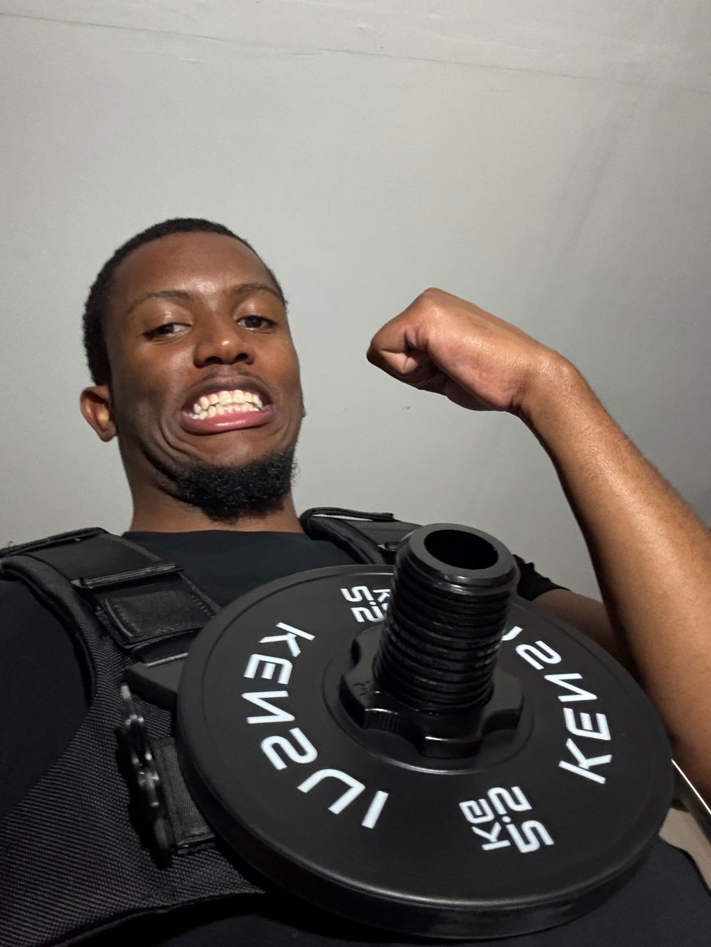 Weight vest loaded with a single large plate, worn outdoors