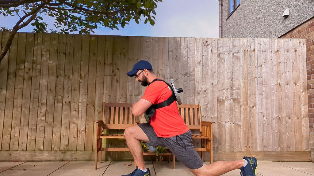 Outdoor lunge performed in a loaded weight vest