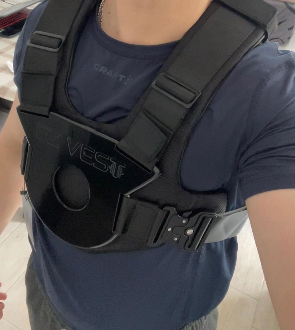 Loaded weight vest worn over a training shirt indoors
